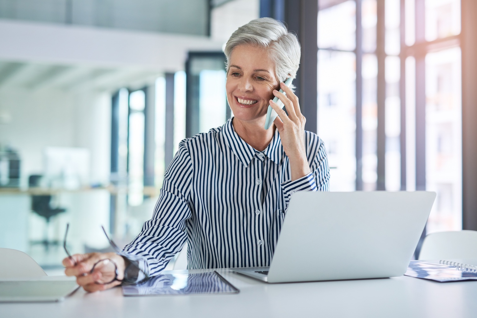 Smiling businesswoman on mobile