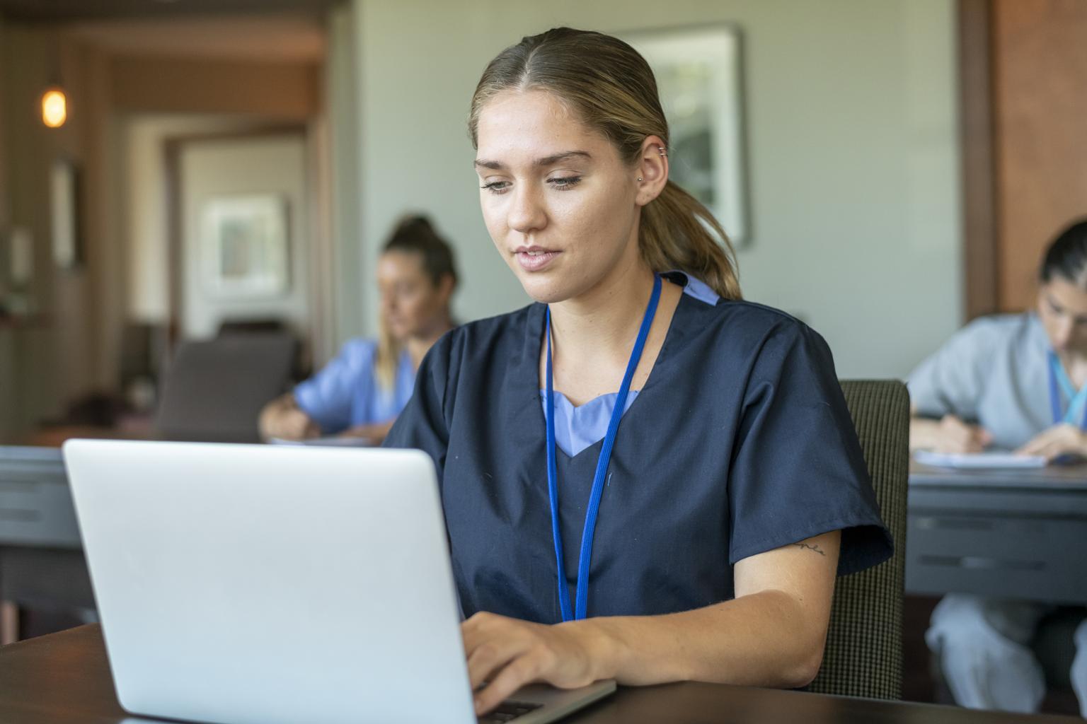 Nursing student using laptop during class