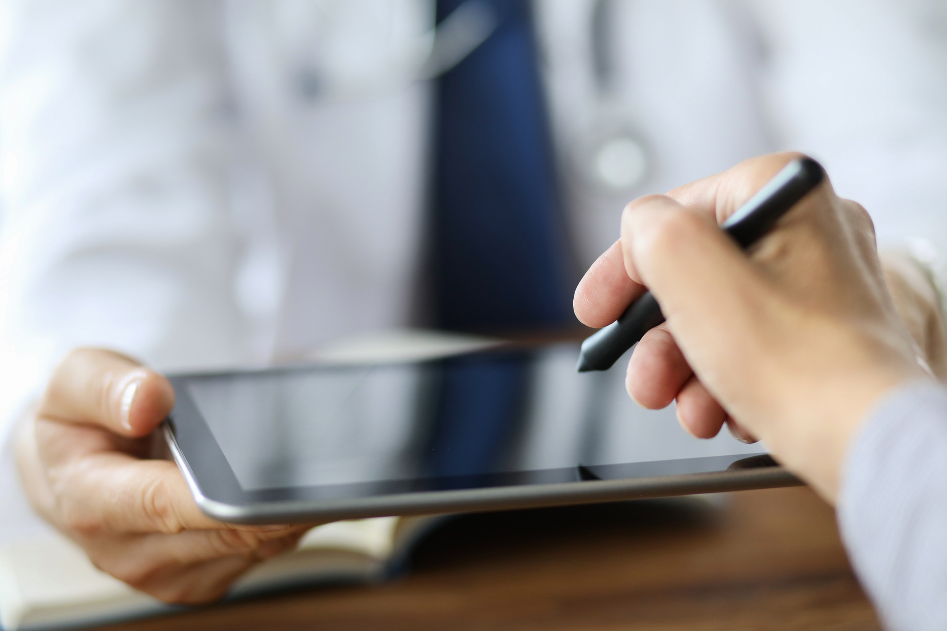 Patient puts an electronic signature on a health insurance contract using a tablet pc.