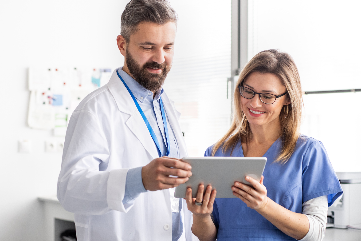 2 Nurses reviewing UpToDate on a tablet.