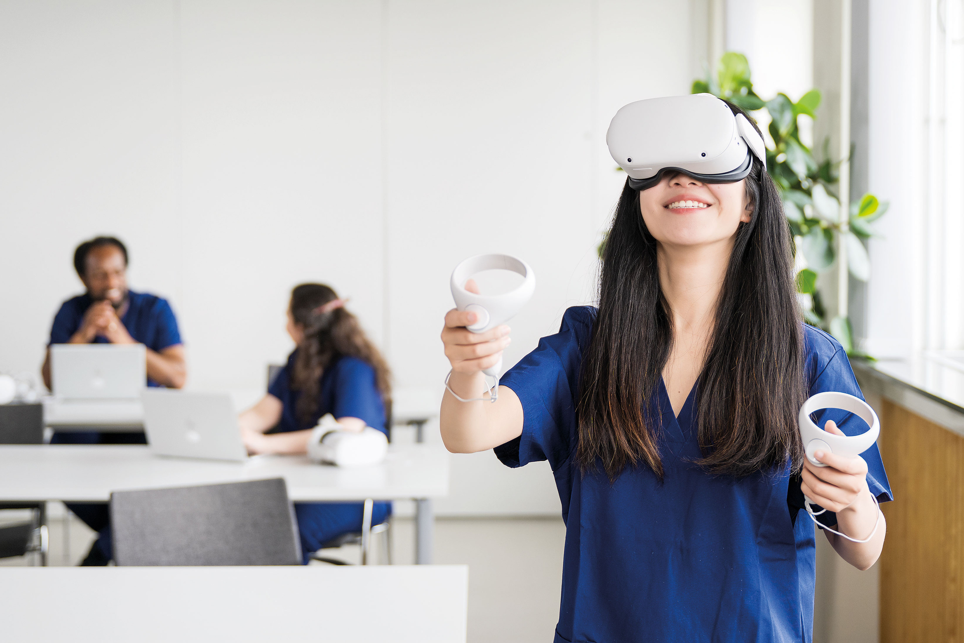 Nursing student wearing VR goggles using vSim