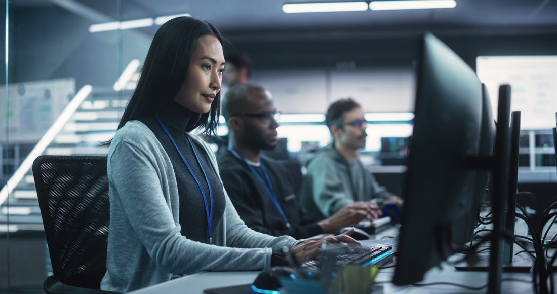 Young Asian Female Software Developer Working on Computer Together with Diverse Creative Colleagues. Data Protection Center with Servers, Storage Hardware and Cyber Security Research