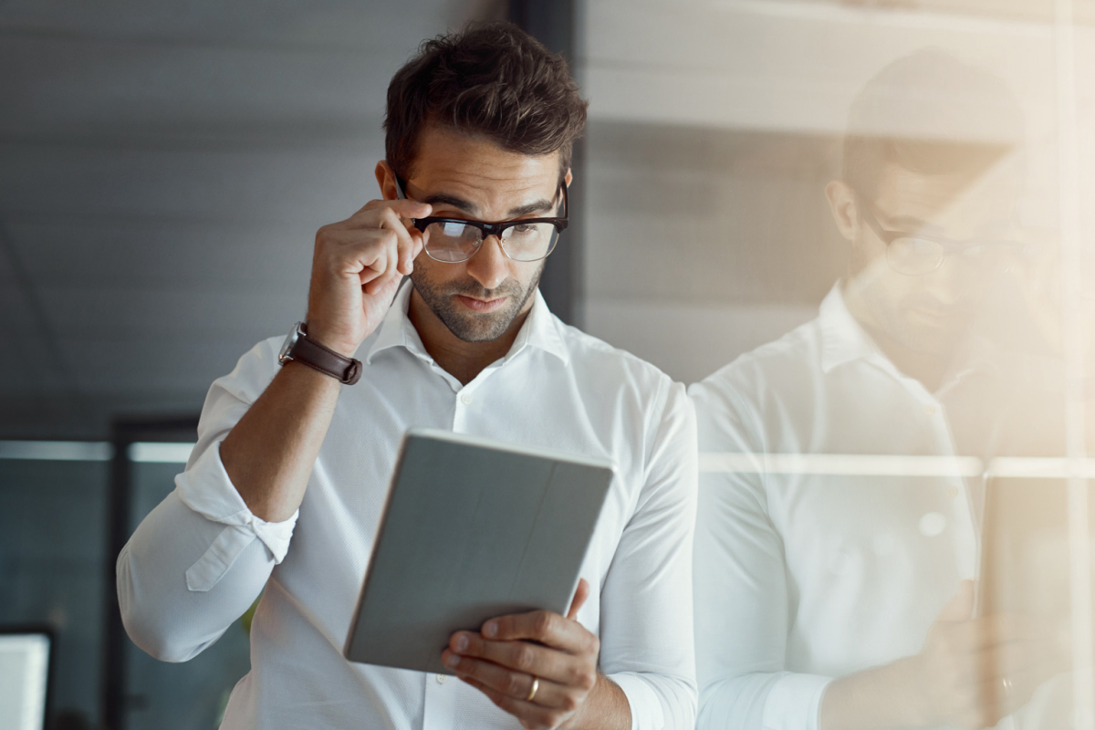 a business man looking at a tablet