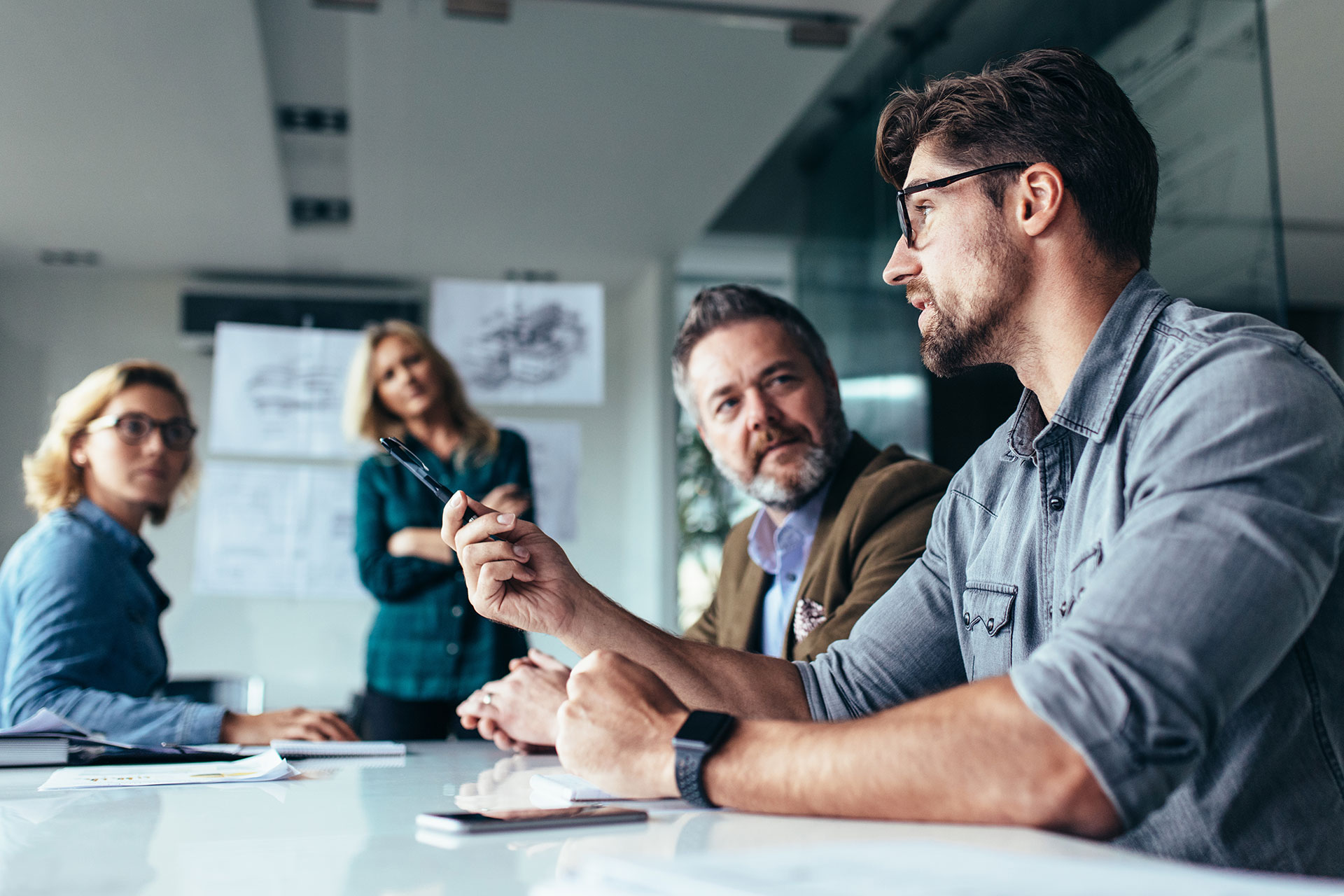 team of marketing professionals at a whiteboard