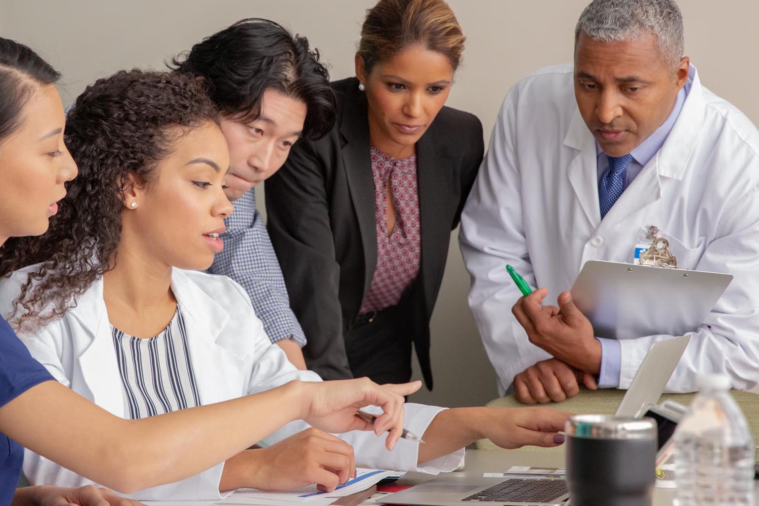 clinicians technicians at conference table with laptop