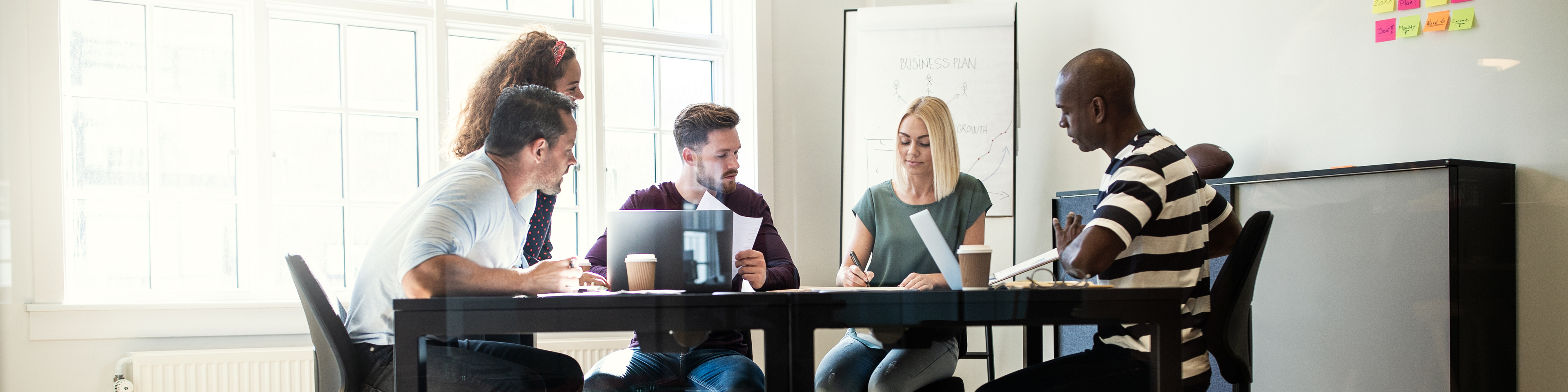 People discussing work together around an office table 