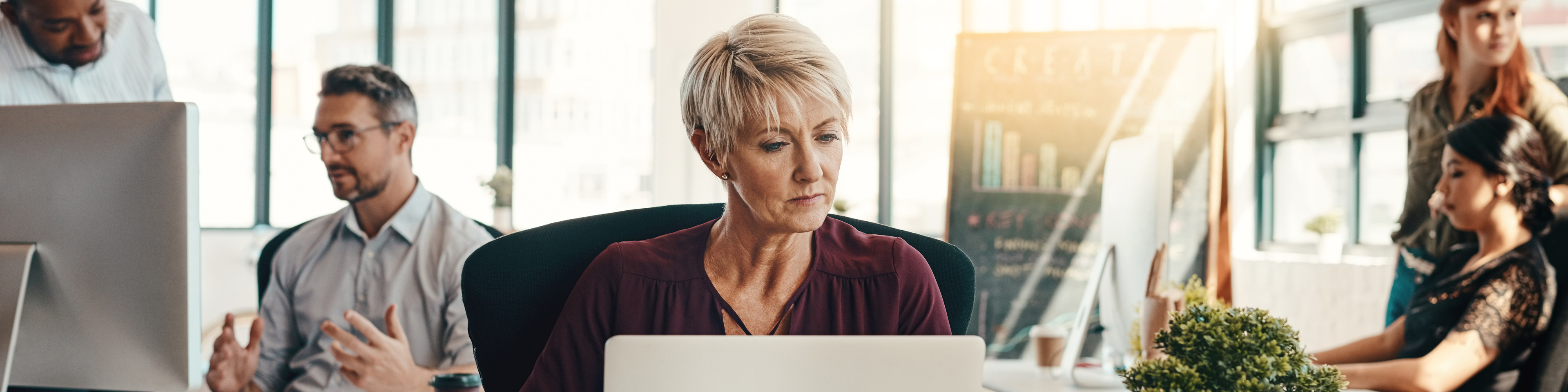 Female on laptop in office setting