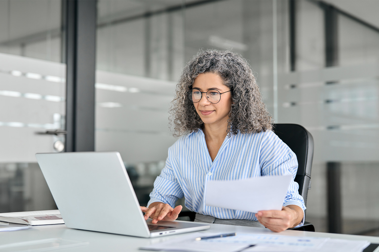 A woman working at a laptop computer