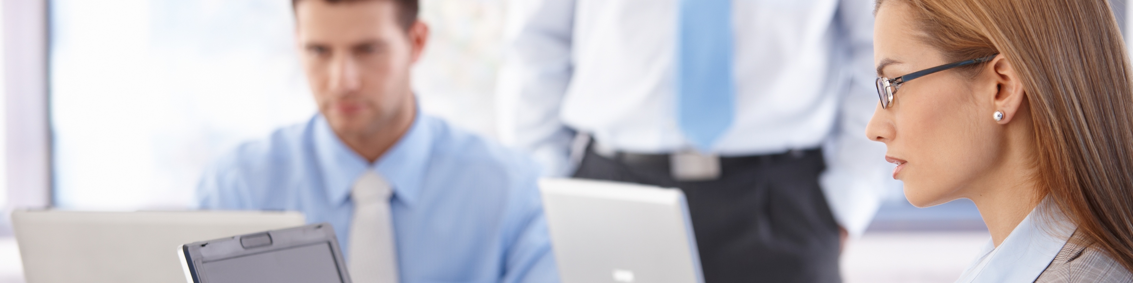 Young casual office workers working on laptop