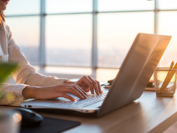 Adult businesswoman working at home using computer, studying business ideas on a pc screen on-line