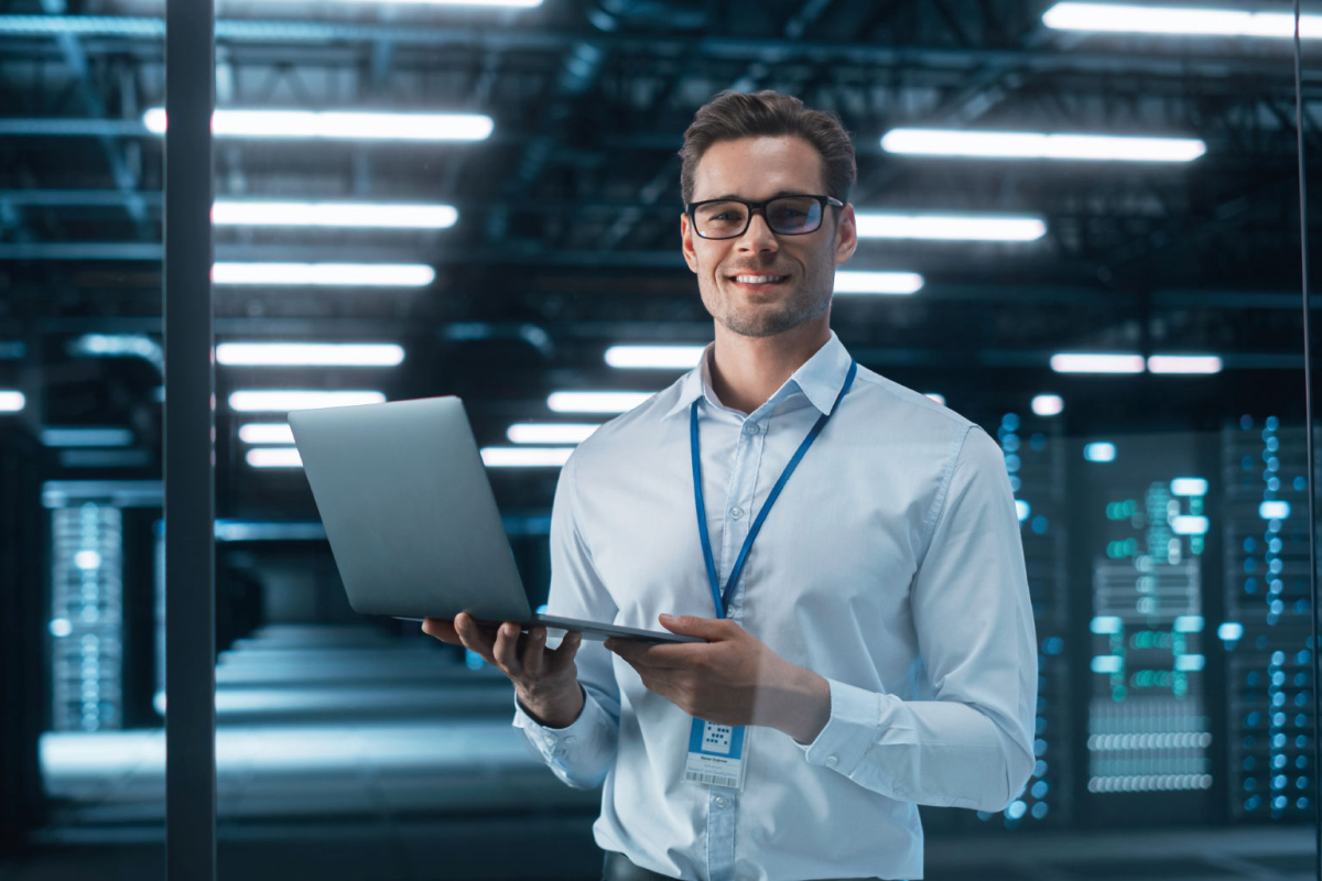 Successful Creative Director Working on Laptop Computer in Big City Office Late in the Evening