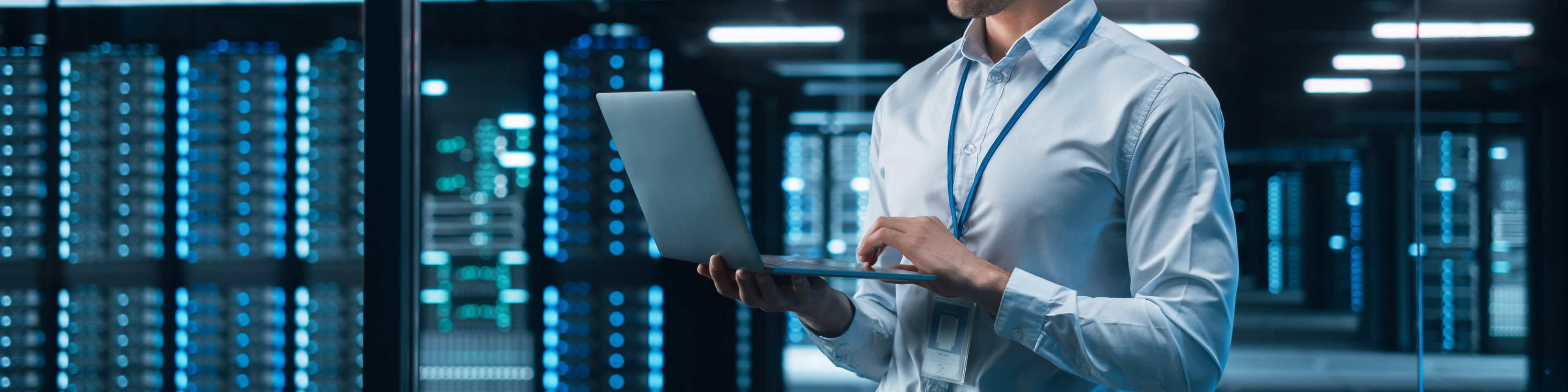 Portrait of IT Specialist Uses Laptop in Data Center