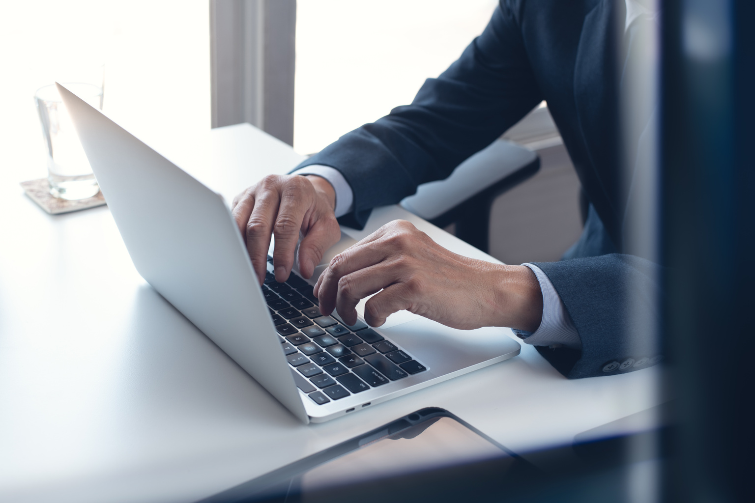 Business man working on laptop computer at modern office