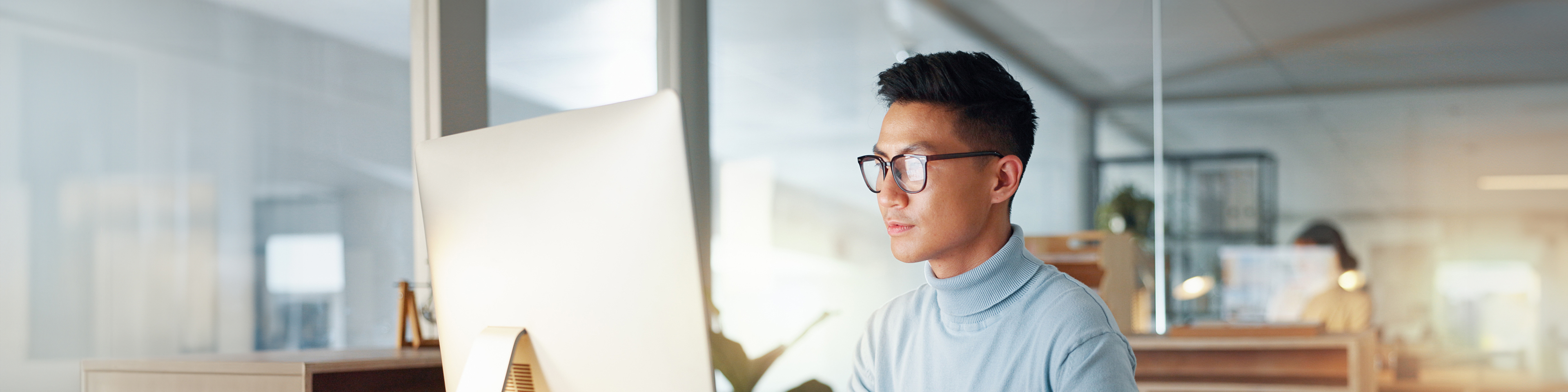 Asian man at computer, glasses and ideas, thinking and reading email, web review or article at digital agency