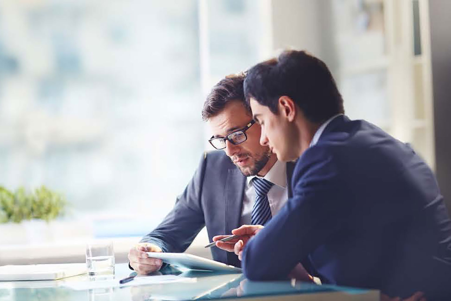 Two business men discussing looking at a document