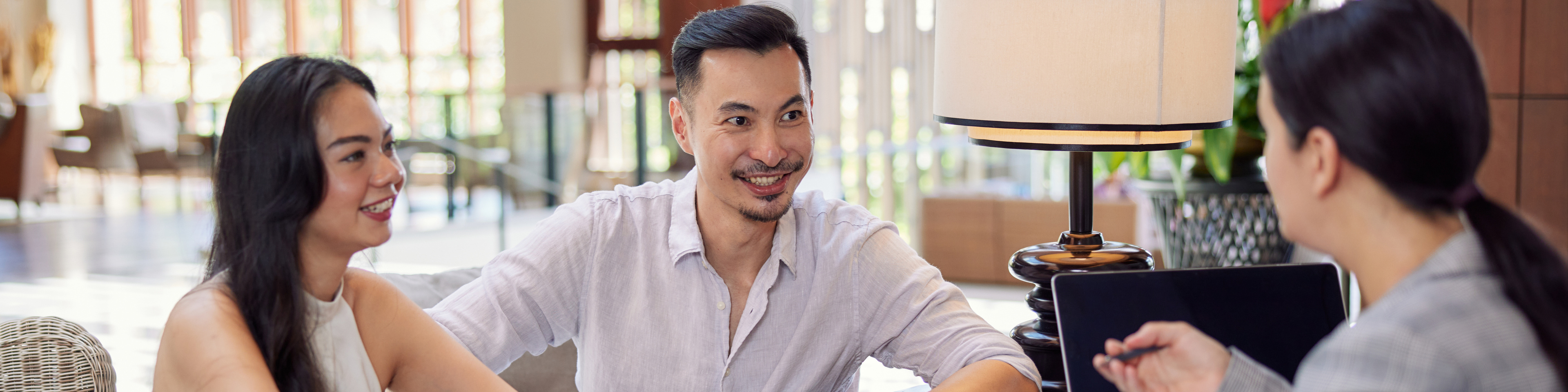 Young asian couple talking to banker