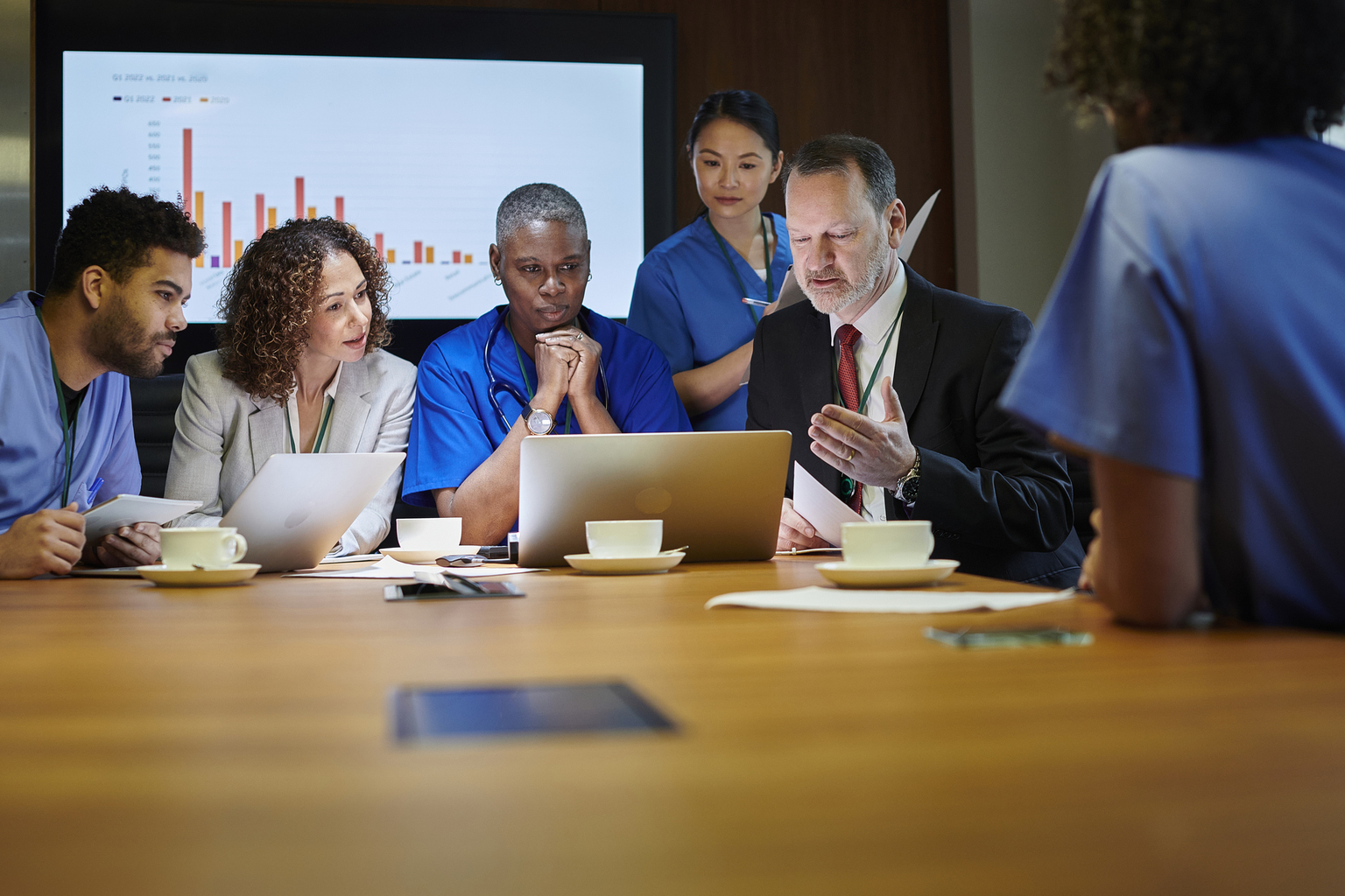 Group of hospital administrators and doctors meet to discuss hiring and onboarding