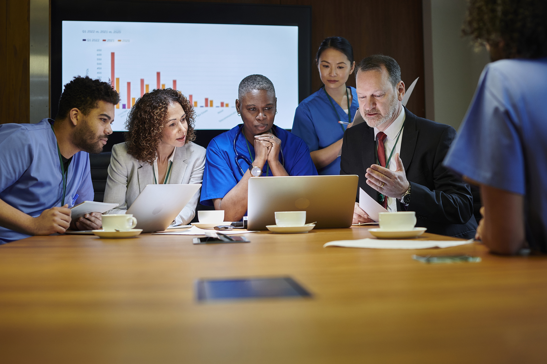 Group of hospital administrators and doctors meet to discuss hiring and onboarding