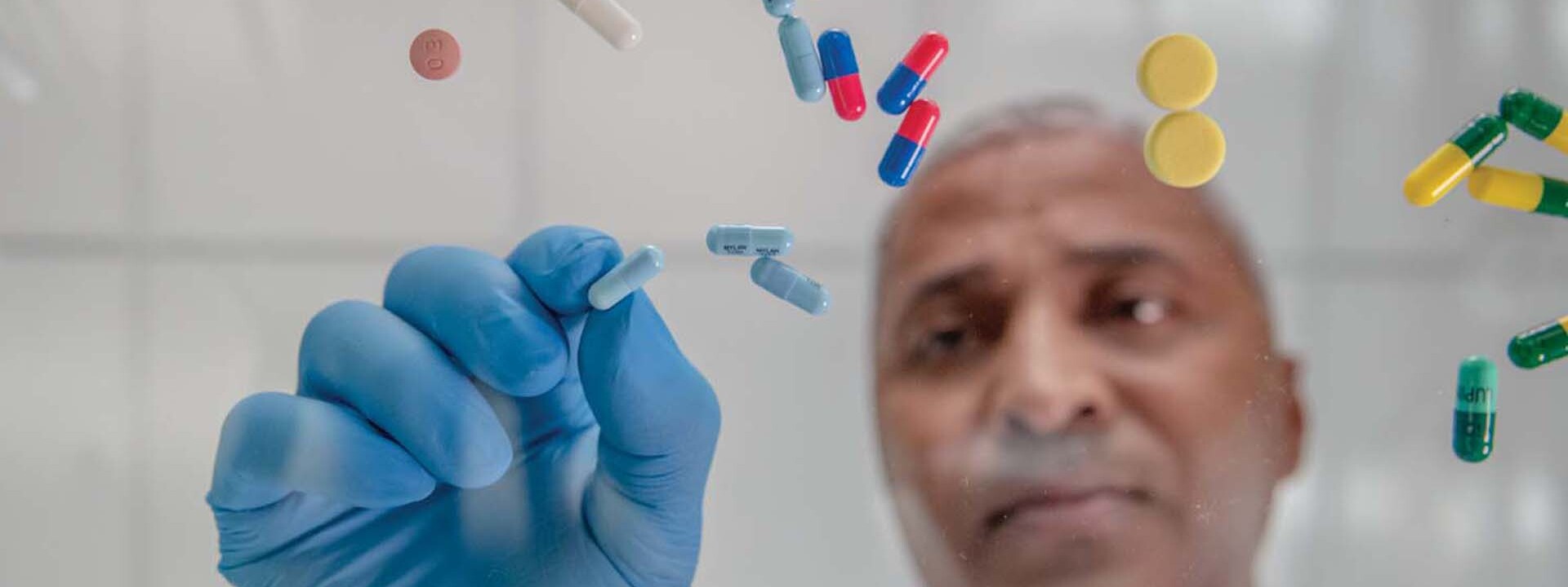 pharmacist sorting through a variety of pills