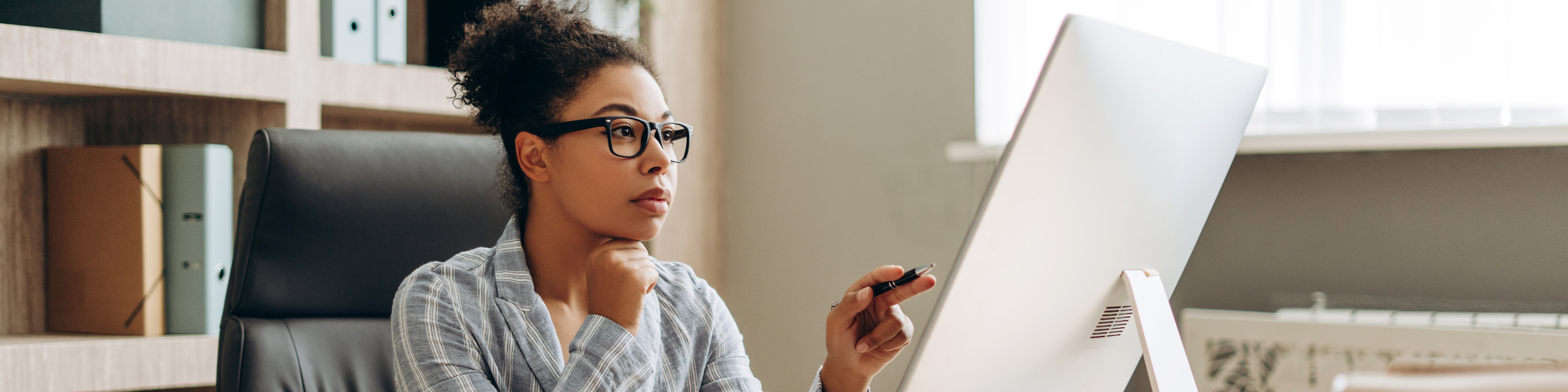 African American businesswoman working on computer in office