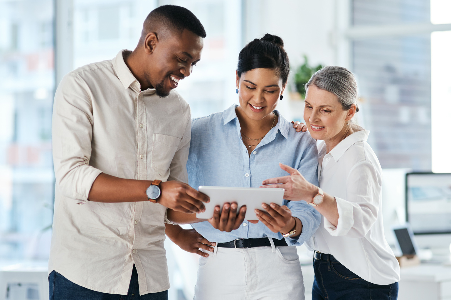 Group of business people using a digital tablet together in an office