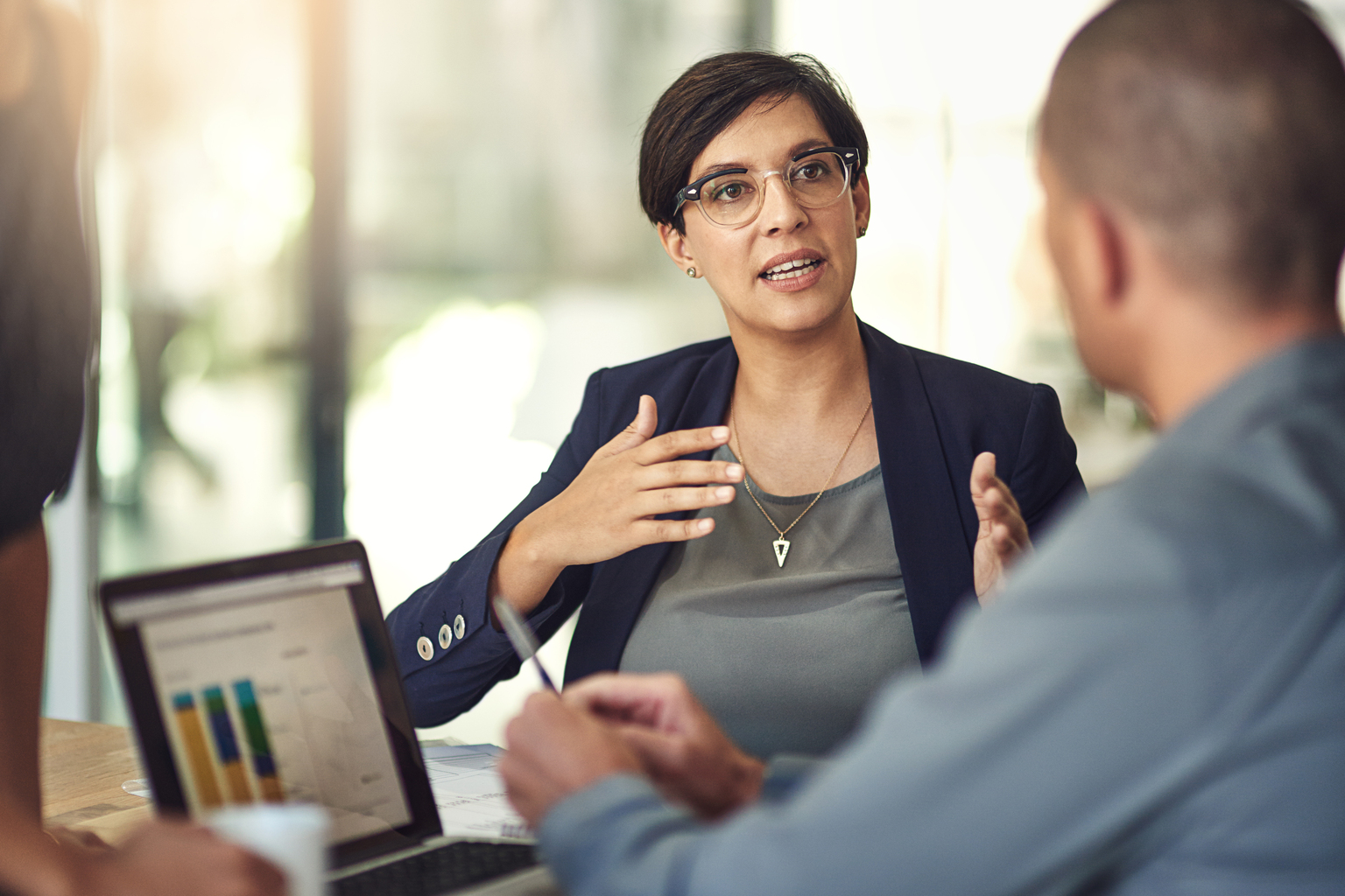 Business woman speaking to others in a data analysis meeting