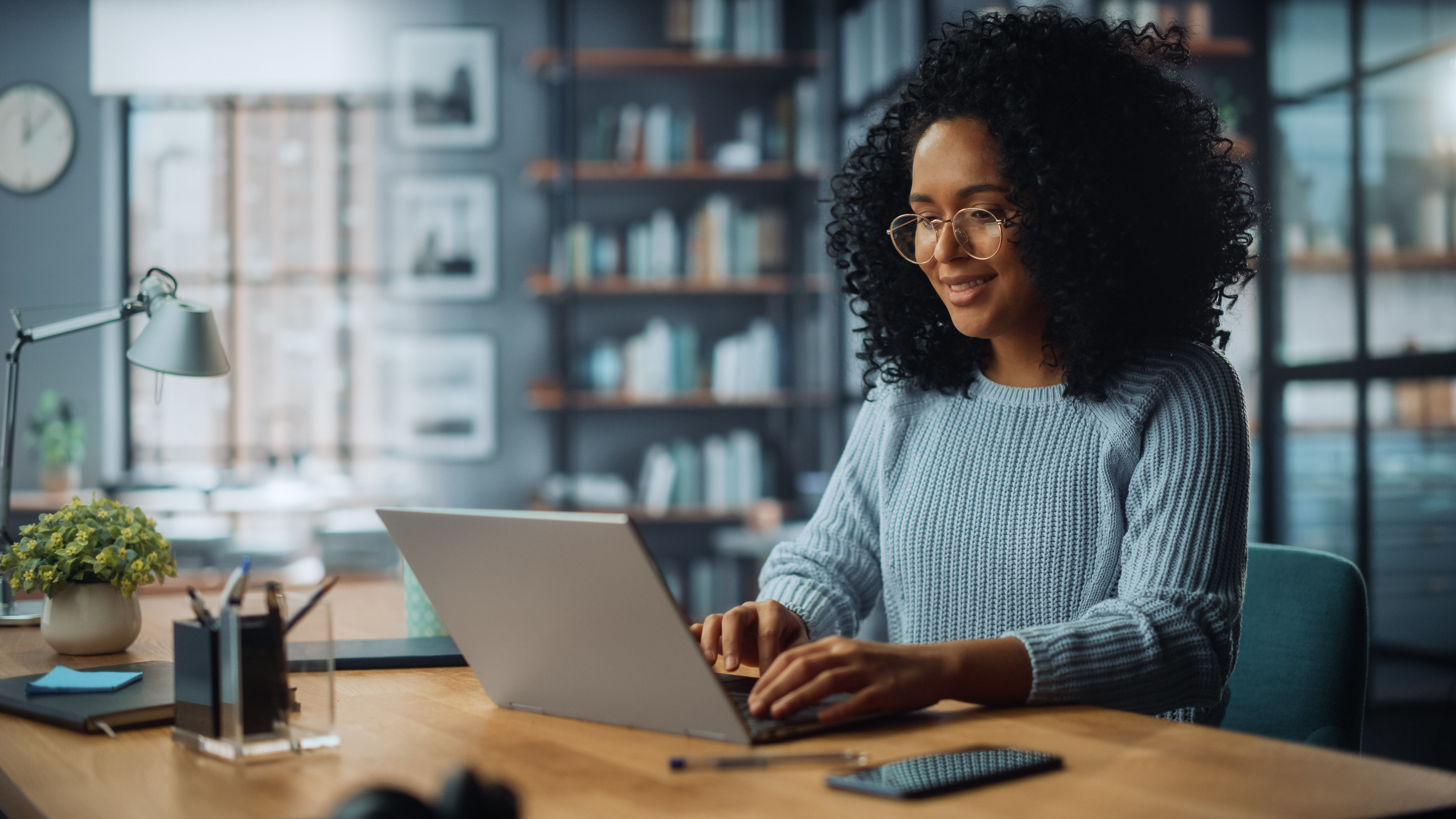 Women typing on laptop at desk