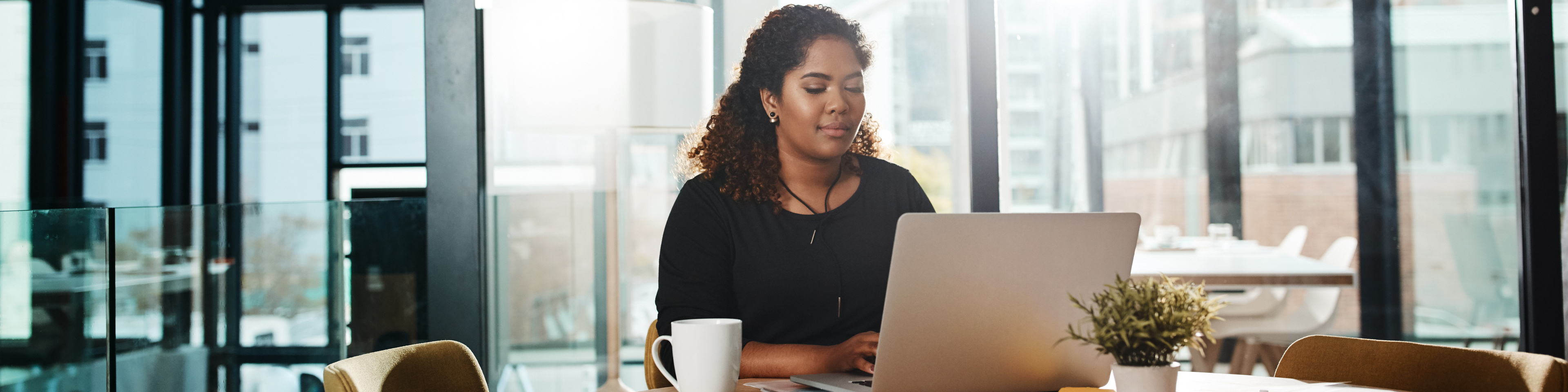 Woman working at laptop in an office