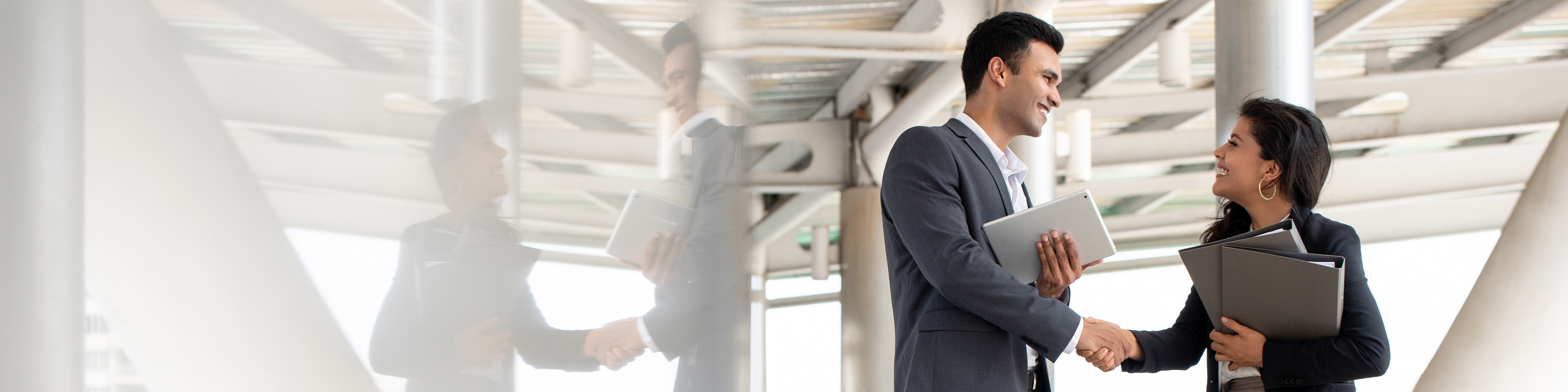 Businesspeople greeting and making handshake