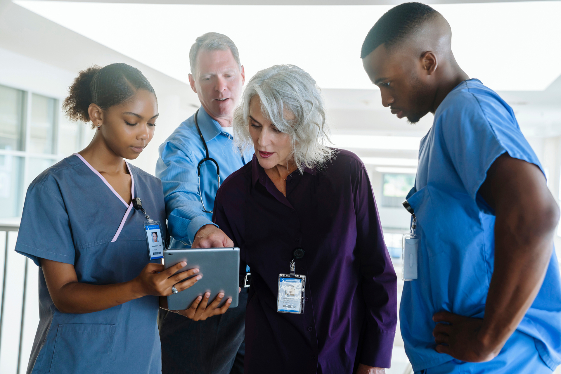 Group of senior hospital leadership and nurses discuss patient care