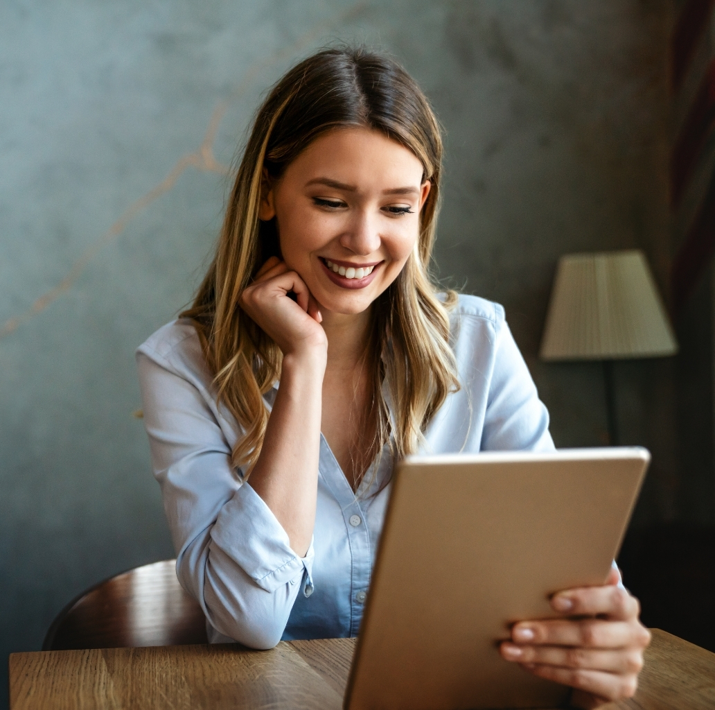 Woman sitting in office watching her tablet from Canva