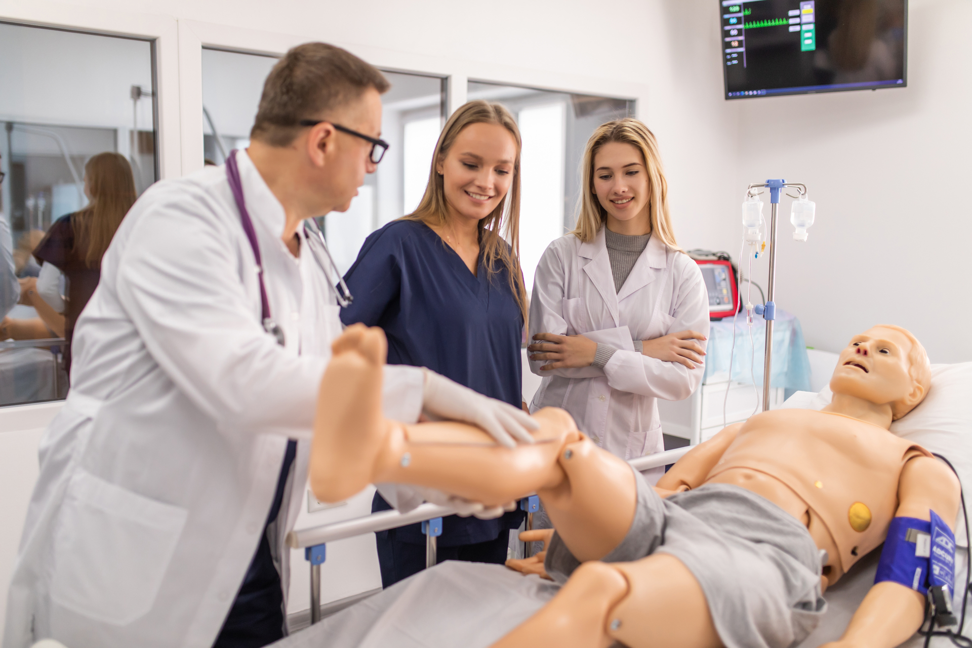 Nursing students watching professor teach in simulation review course