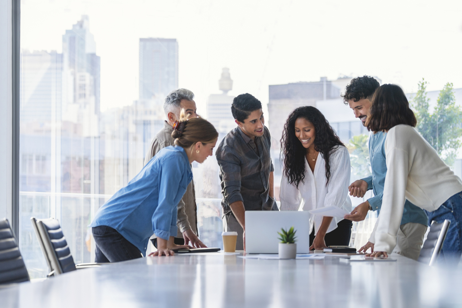 Team of business people working together in a board room