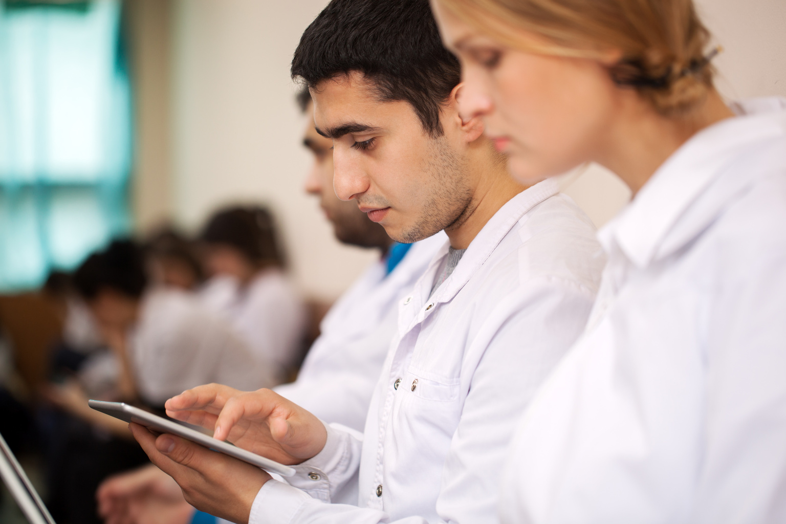 Medical students engaged in learning using laptop