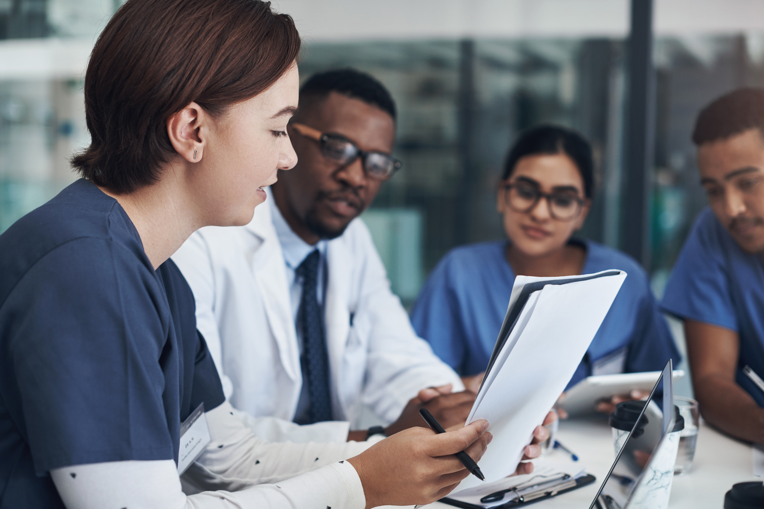 Shot of a group of nurses and doctors having a meeting together.