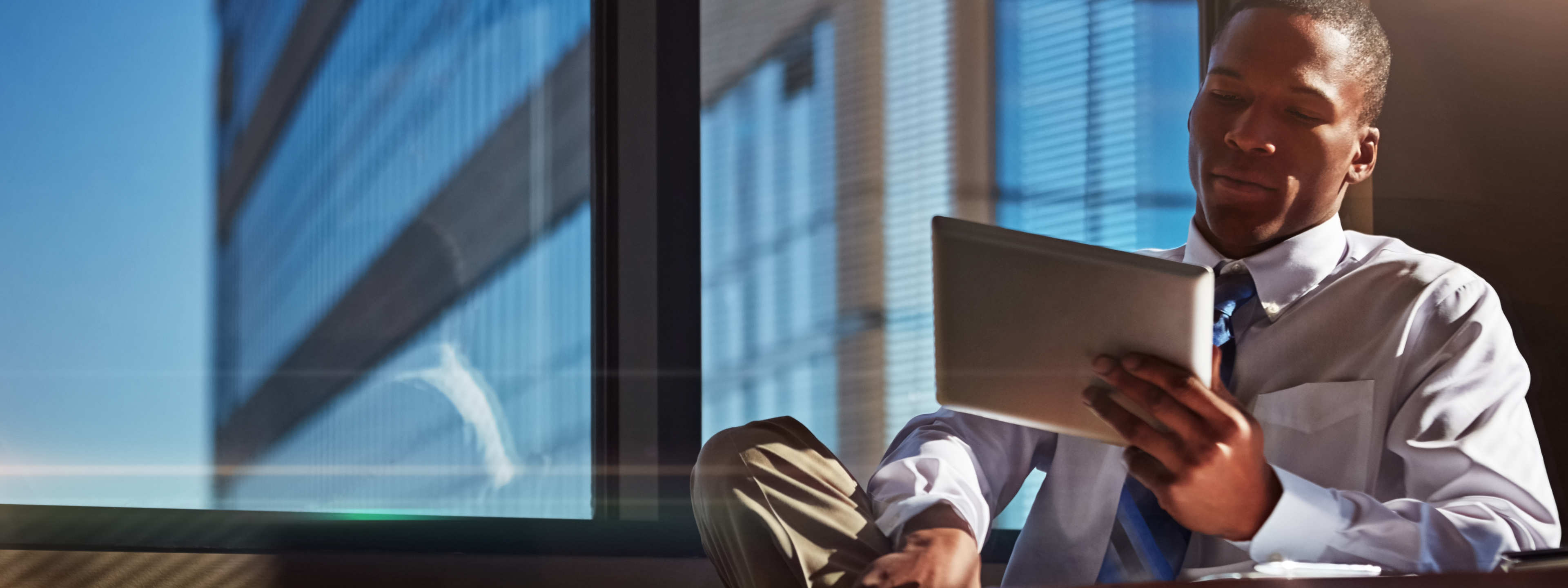 sitting man holds tablet