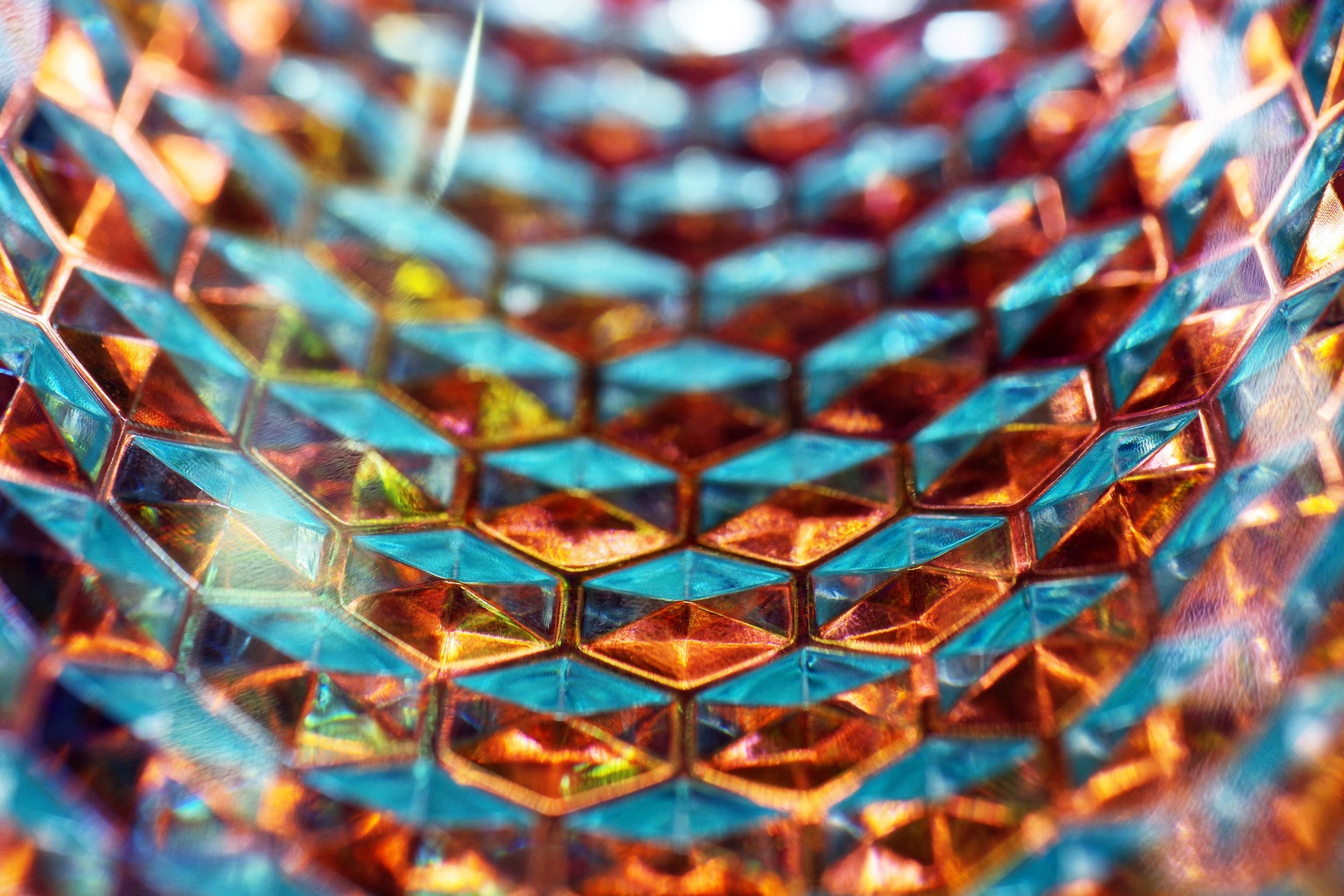 Close up of concave acrylic glass surface, with hexagon texture and light effects