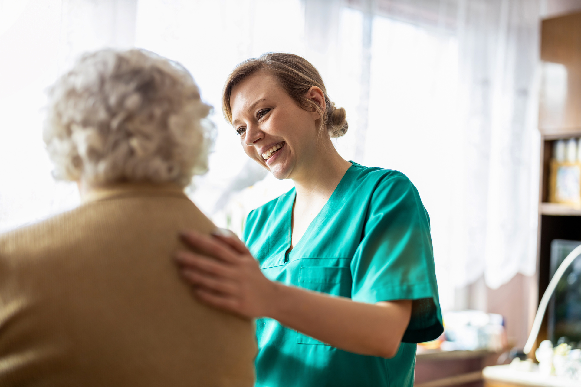 Friendly nurse helping patient