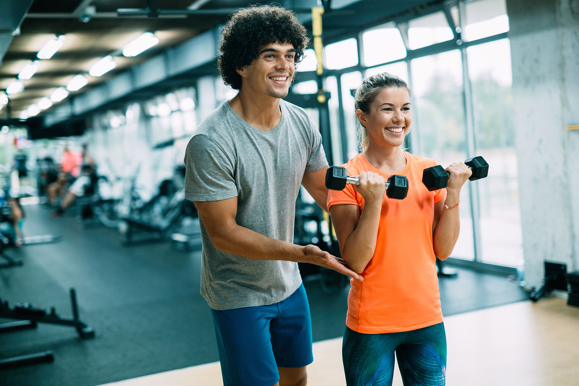 Male personal trainer working with a female client