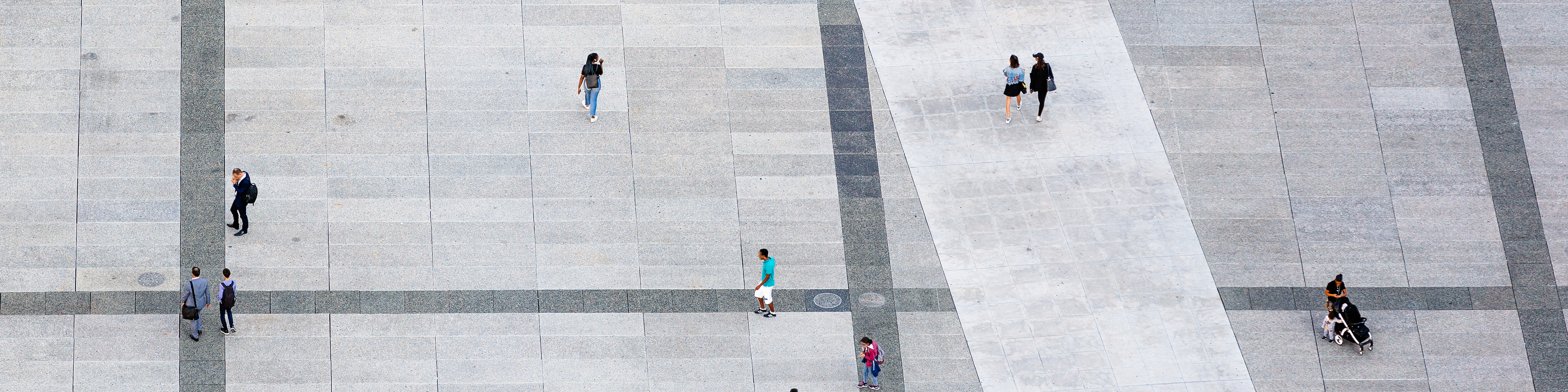 Aerial view of people walking at the city square,