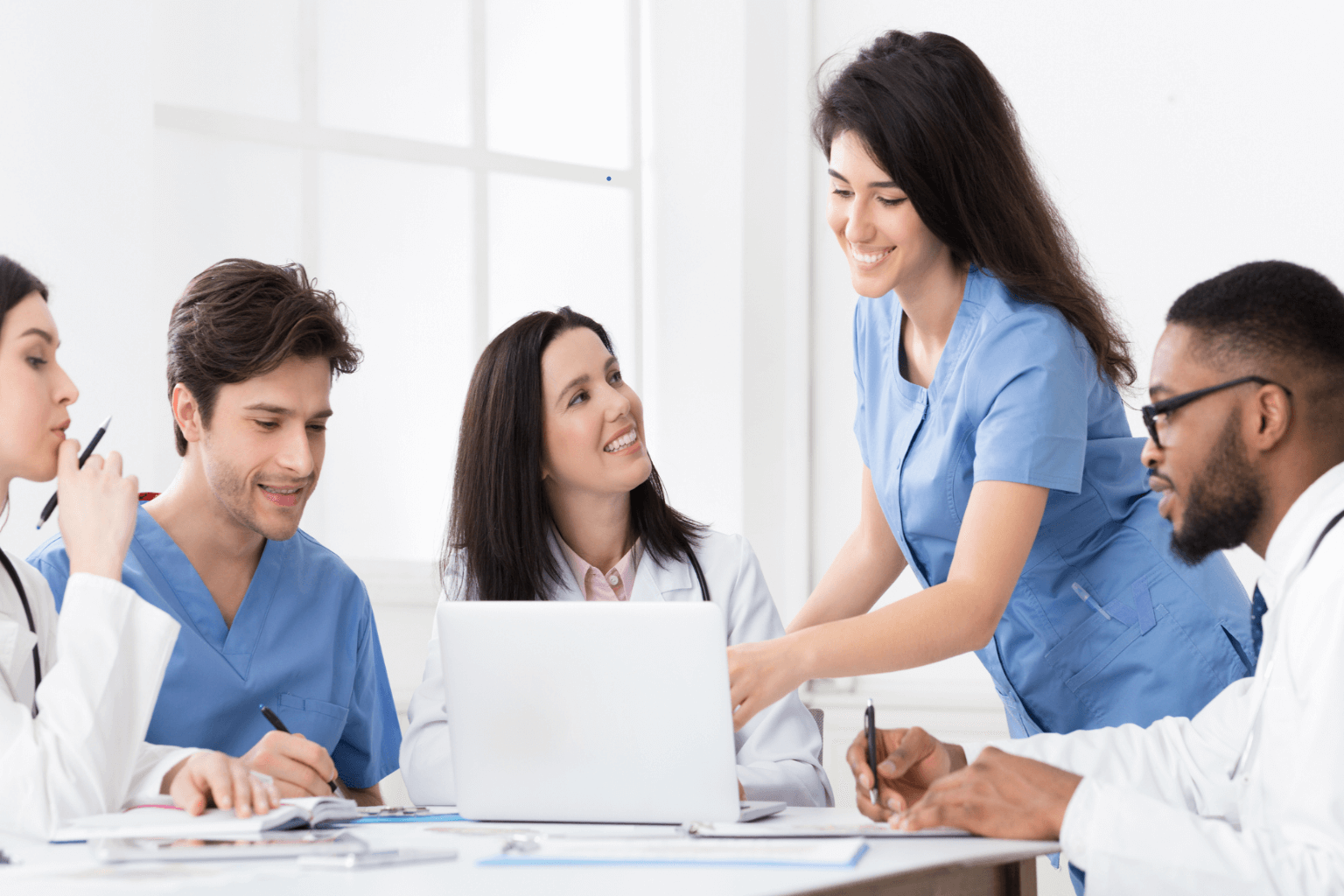 Practitioners-discussing-medical-reports-on-laptop