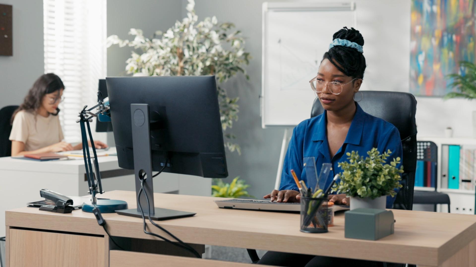 Business professional works on computer in modern office.