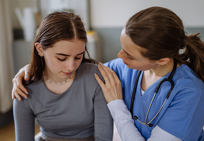 Medical professional comforts human trafficking victim