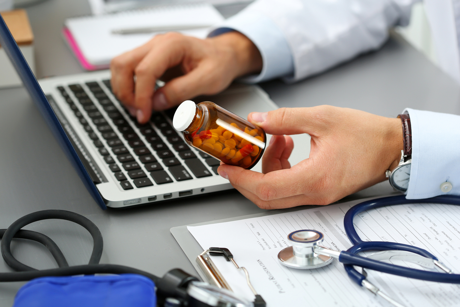 Pharmacist with laptop and medicine 