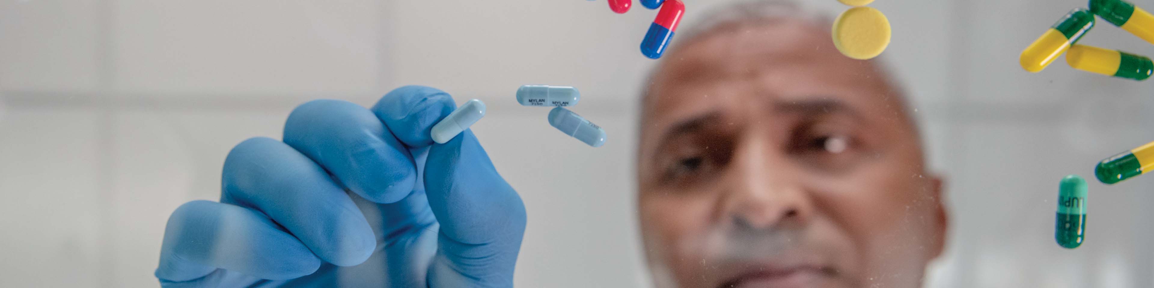 pharmacist sorting through a variety of pills