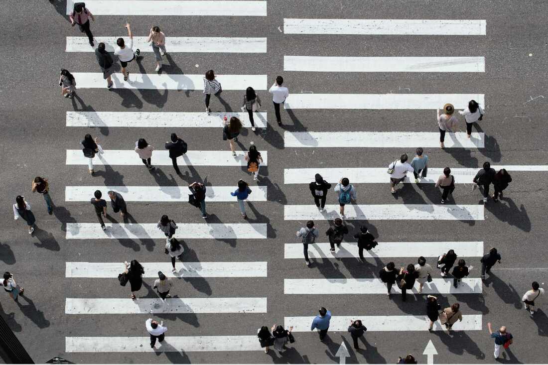 Overhead view of people crossing crosswalk