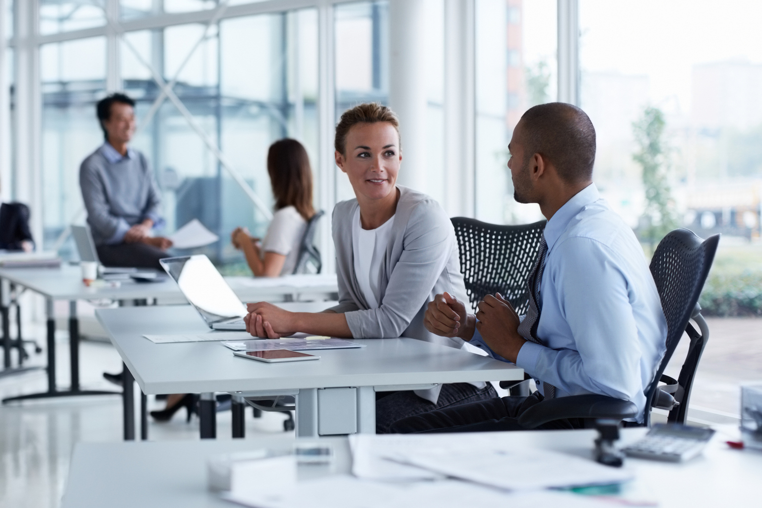 Businesswoman discussing with male colleague at office