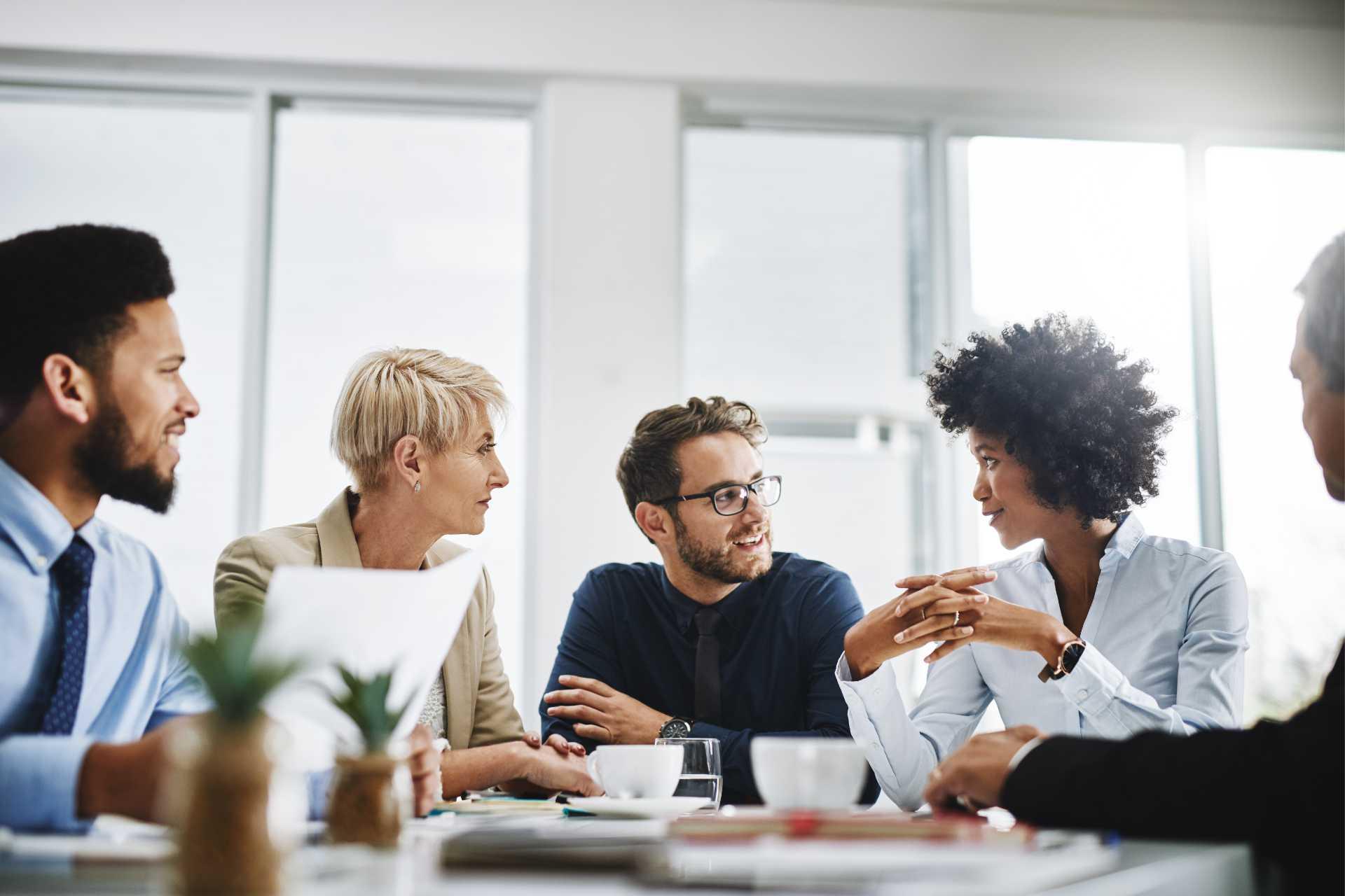 Group of professionals meet at office table