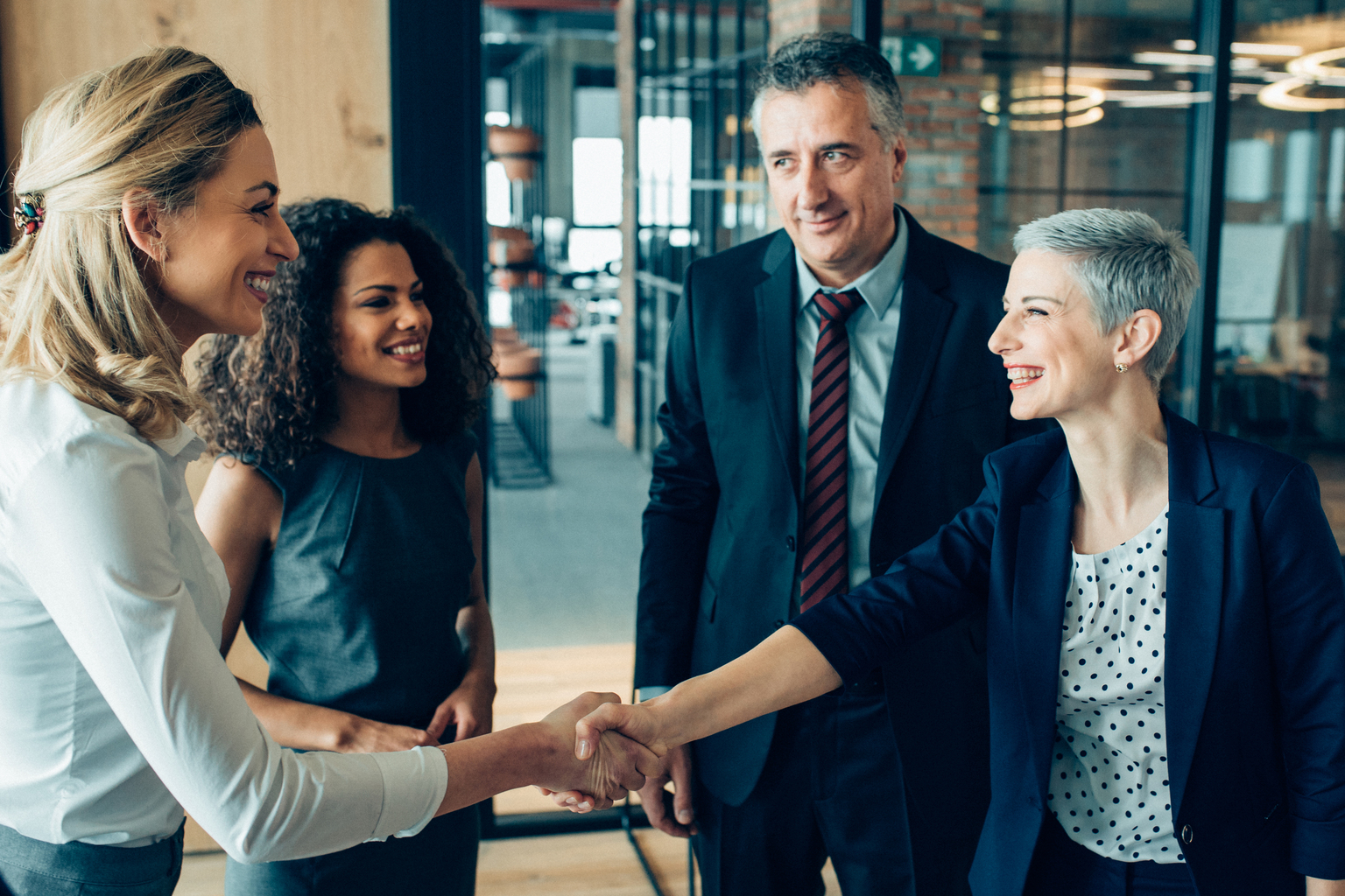 Business people shaking hands after the meeting.