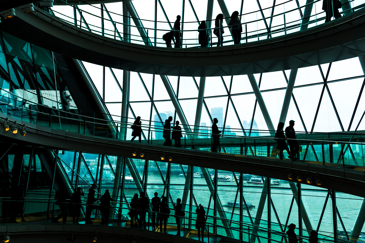 Abstract modern architecture and silhouettes of people on spiral staircase 
